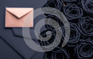 Love letter and flowers delivery on Valentines Day, luxury bouquet of roses and card on charcoal background for romantic holiday