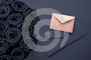 Love letter and flowers delivery on Valentines Day, luxury bouquet of roses and card on charcoal background for romantic holiday