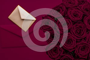 Love letter and flowers delivery on Valentines Day, luxury bouquet of roses and card on maroon background for romantic holiday