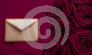 Love letter and flowers delivery on Valentines Day, luxury bouquet of roses and card on maroon background for romantic holiday