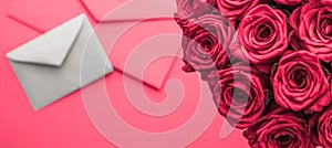 Love letter and flowers delivery on Valentines Day, luxury bouquet of roses and card on pink background for romantic holiday