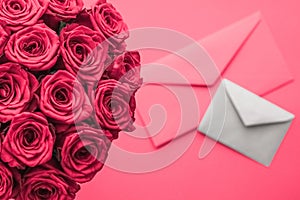 Love letter and flowers delivery on Valentines Day, luxury bouquet of roses and card on pink background for romantic holiday