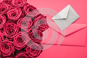 Love letter and flowers delivery on Valentines Day, luxury bouquet of roses and card on pink background for romantic holiday