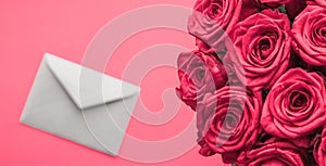 Love letter and flowers delivery on Valentines Day, luxury bouquet of roses and card on pink background for romantic holiday