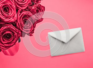 Love letter and flowers delivery on Valentines Day, luxury bouquet of roses and card on pink background for romantic holiday