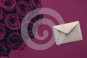 Love letter and flowers delivery on Valentines Day, luxury bouquet of roses and card on wine background for romantic holiday