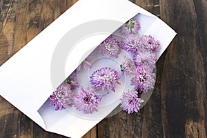 Love Letter with Flowers on Rustic Wooden Background