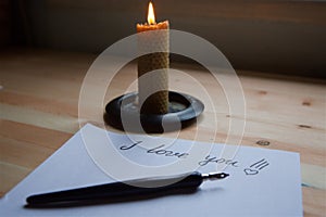 Love letter on white paper and candle