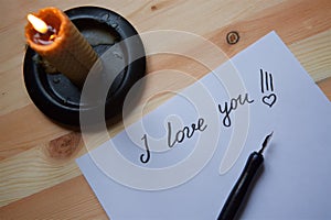 Love letter on white paper and candle