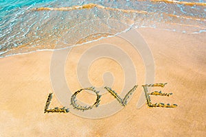 LOVE lettering on the beach with wave,Copy space