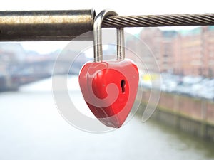 Love lock as a symbol of love and unity hanging on a bridge railing