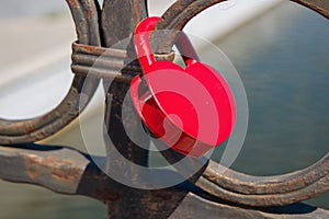 Love lock heart shape of red color hanging on bridge. Old castom to hand on bridge the locks symbol long term