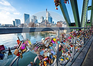 Love Locks at Eiserner Steg (Iron Footbridge) at River Main and skyscrapers skyline - Frankfurt, Germany