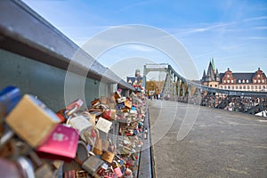 the love locks are placed on the bridge over the river