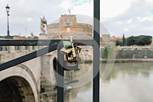Love locks on sant`angelo castle blurred background in rome, valentine`s day