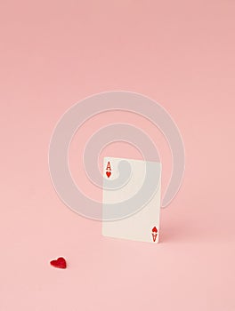 Love, luck and heart symbol. Runaway red heart from ace of heart.Minimal creative concept with copy space on pink background
