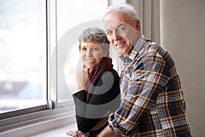 Love matures with age. Portrait of a senior couple enjoying an affectionate moment by the window.