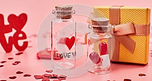 Love medicine. I love you .Tablets in jars are kissing Valentine`s Day. Love background. Gifts in the form of hearts on a pink