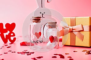 Love medicine. I love you .Tablets in jars are kissing Valentine`s Day. Love background. Gifts in the form of hearts on a pink