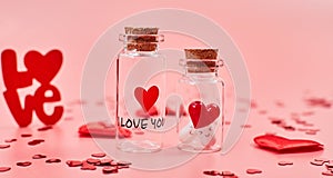 Love medicine. I love you .Tablets in jars are kissing Valentine`s Day. Love background. Gifts in the form of hearts on a pink