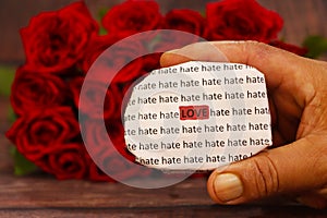 Love message with Red roses in a bunch as a background.