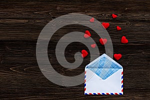 Love message written in wooden blocks with red heart, white wood background.