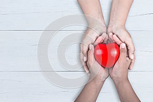 Love Mom Concept : Woman holds her young kids hands supporting r photo