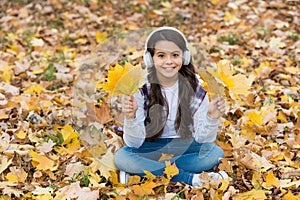 In love with nature. autumn kid fashion. inspiration. happy childhood. back to school. girl among maple leaves in park