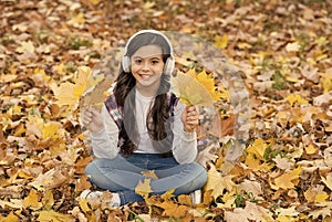 In love with nature. autumn kid fashion. inspiration. happy childhood. back to school. girl among maple leaves in park