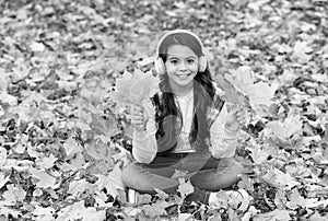 In love with nature. autumn kid fashion. inspiration. happy childhood. back to school. girl among maple leaves in park