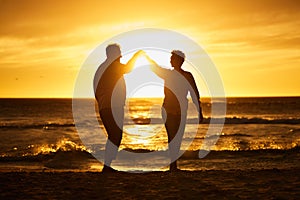 Love, ocean and sunset, silhouette of couple on beach holding hands in Bali. Waves, romance and man and woman dancing in