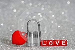 Love padlock with a red heart pendant photo
