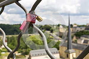 Love padlocks on the fence on the city background.