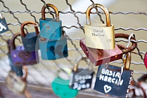 Love padlocks hanging on bridge