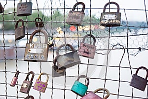 Love padlocks hanging on bridge
