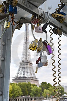 Love padlocks hanging on a bridge in Paris France