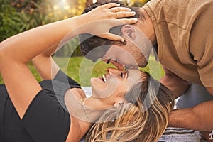 Love, park and couple kiss on picnic date to show affection, bonding and romance. Relationship, dating and young man