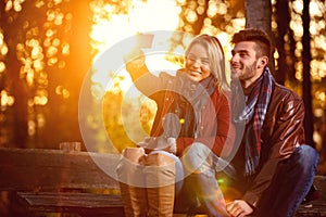 Love in the park- happy couple in the park taking selfie