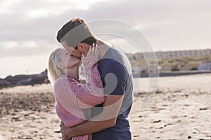Love and passion for caucasian young couple in outdoor leisure activity. romantic and tenderness kiss with man and girl at the