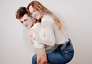 love, passionate and beautiful couple have fun against the white wall.