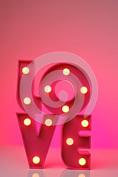 Love.Pink lettering love on a neon pink background.Relationships and feelings. Valentine's Day. Inscriptions and slogans