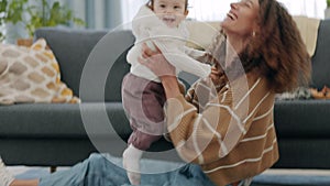 Love, play and care with baby and mother in living room of happy family home together. Trust, kiss and smile with mom