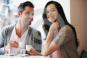 Love, portrait and couple with coffee on date for romance or anniversary in cafeteria. Happy, bonding and young man and