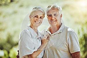 Love, portrait or happy old couple in nature or park bonding or hugging in a happy marriage partnership. Retirement