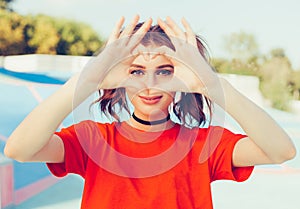 Love. Portrait smiling happy young redhead woman, making heart sign, symbol with hands. Positive human emotion expression feeling