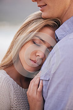 Love always protects. a happy young couple enjoying a romantic moment on the beach.