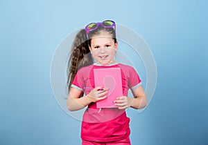 Love reading book. small happy girl in glasses with notebook. making plans for summer holidays and vacation. reading