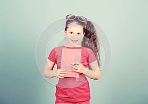 Love reading book. small happy girl in glasses with notebook. making plans for summer holidays and vacation. reading