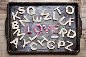 Love in red icing amongst letter shaped cookies