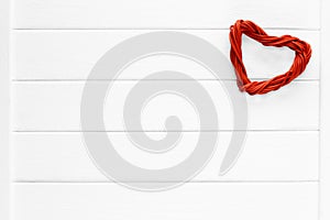 Love red pedig rattan heart on wooden light background